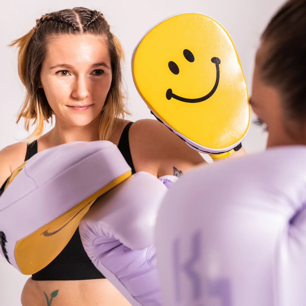 Two boxers practice with KOstudio pads and gloves