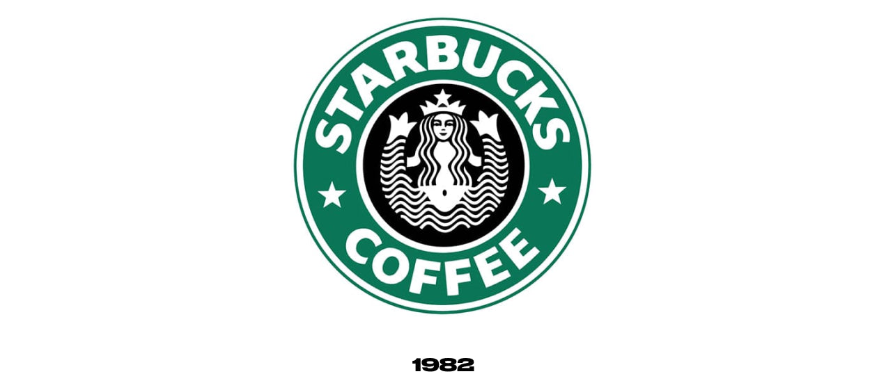 Starbucks logo from 1982 featuring a more abstract version of the siren from the earlier logo with her long hair now concealing her chest. The drawing is still in black and white, but is now surrounded by a green circle with the words "Starbucks Coffee".