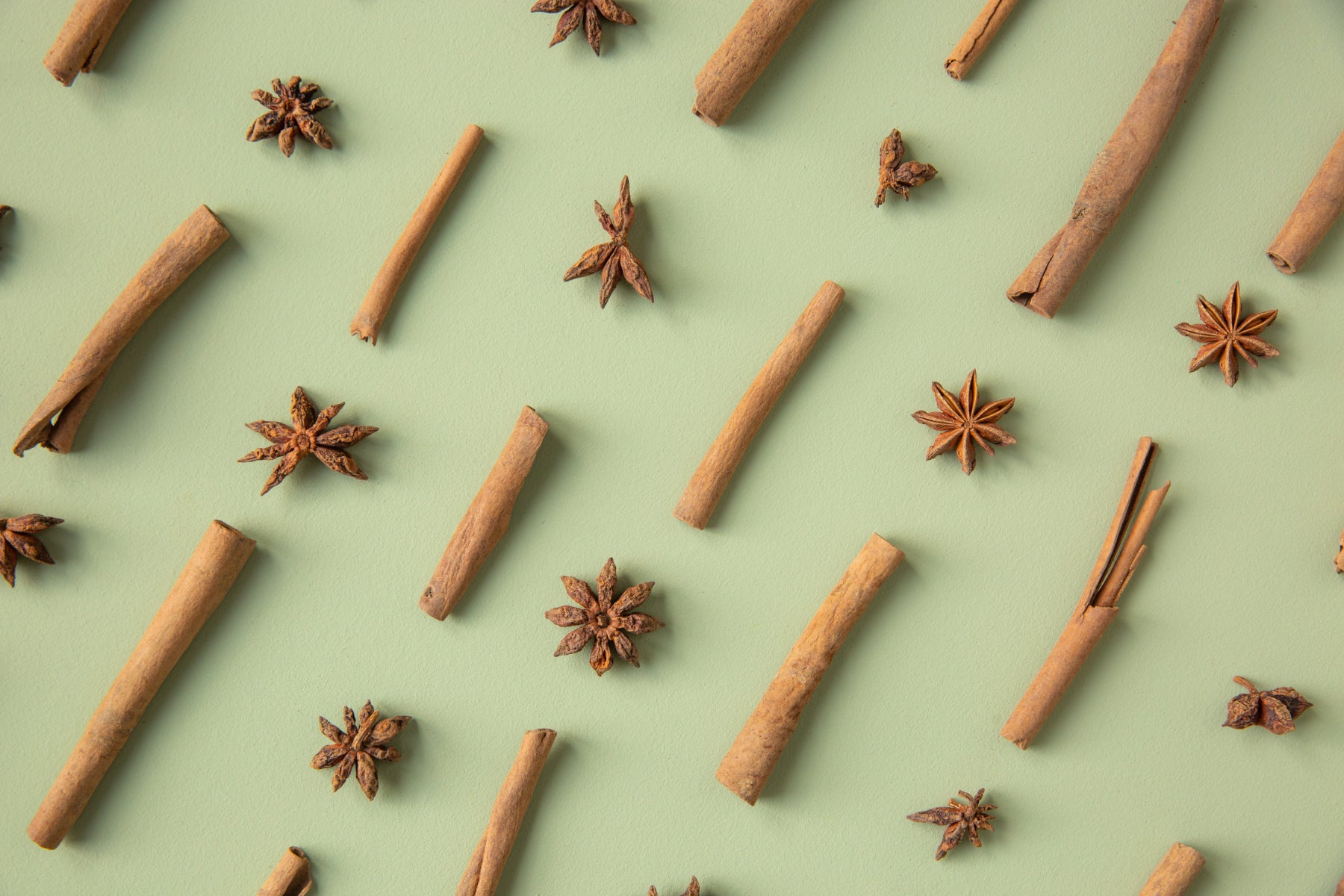 Star anise and cinnamon arranged in a pattern