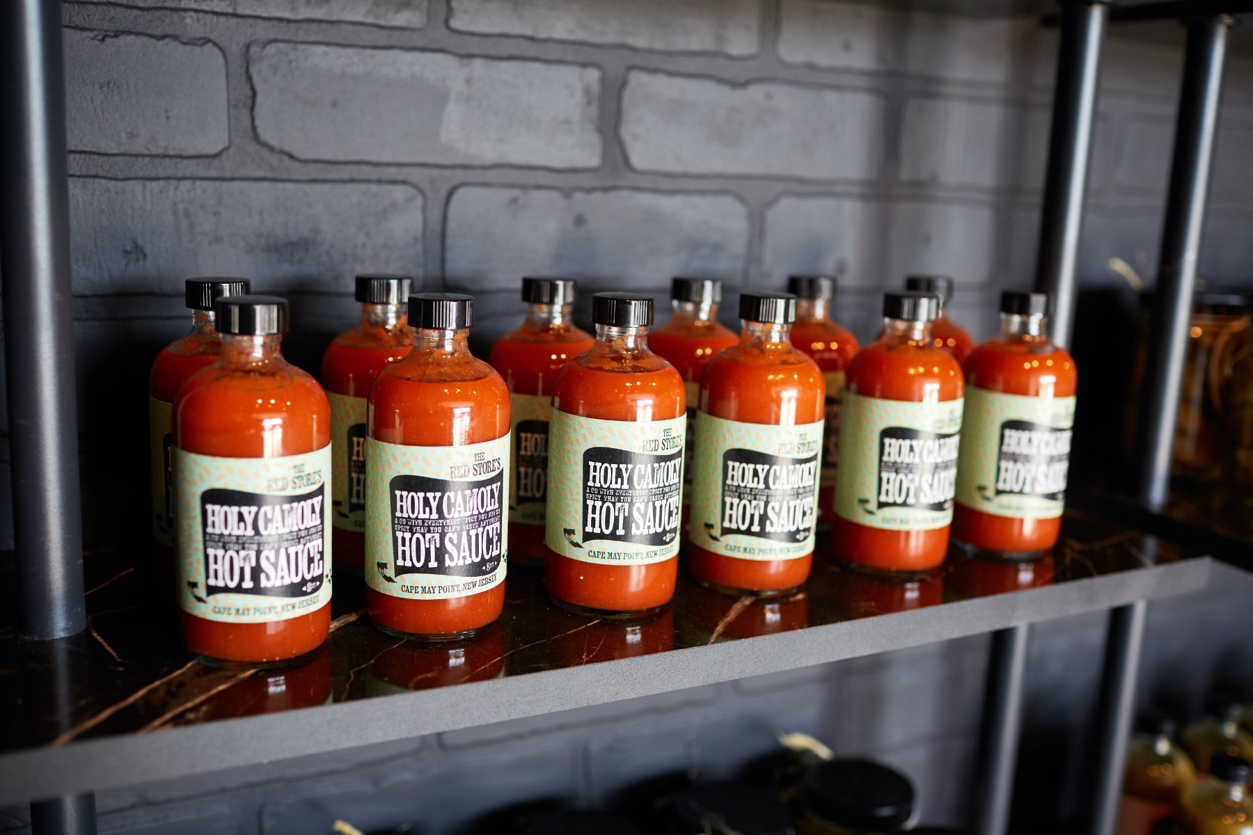 Hot sauce bottles arranged on a shelf