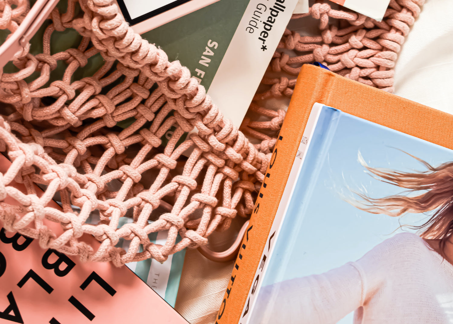 mesh bag holds a number of books and magazines