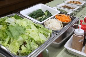 a buffet with lettuce and other vegetables in trays at Country Hotel Takayama in Takayama