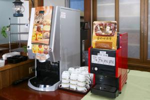 a coffee machine and a drink dispenser on a counter at Country Hotel Takayama in Takayama