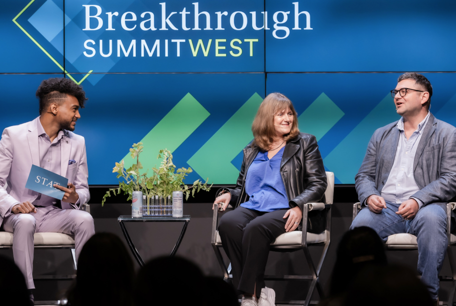 Patricia Brennan and Theofanis Karaletsos are seated on a panel discussing AI.