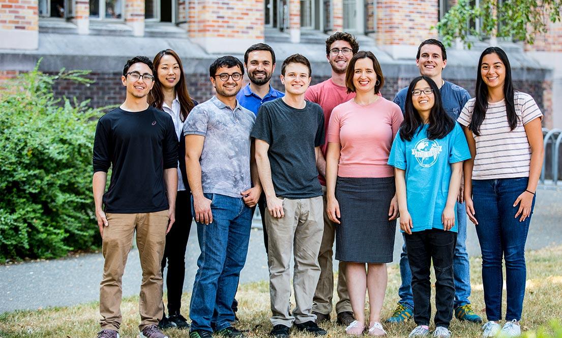 smiling group of students outside on the University of Washington campus