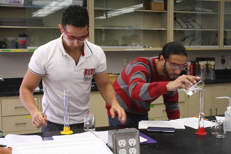 Recipe for success: Above, students Hamza Mujaddidi (left) and Ahmad Jaffar work on their lab experiment in General Chemistry II. Below, Holly Webb synthesizes salicylic acid in chemistry lab. 
Photo by Tora Thuland - Staff Photographer