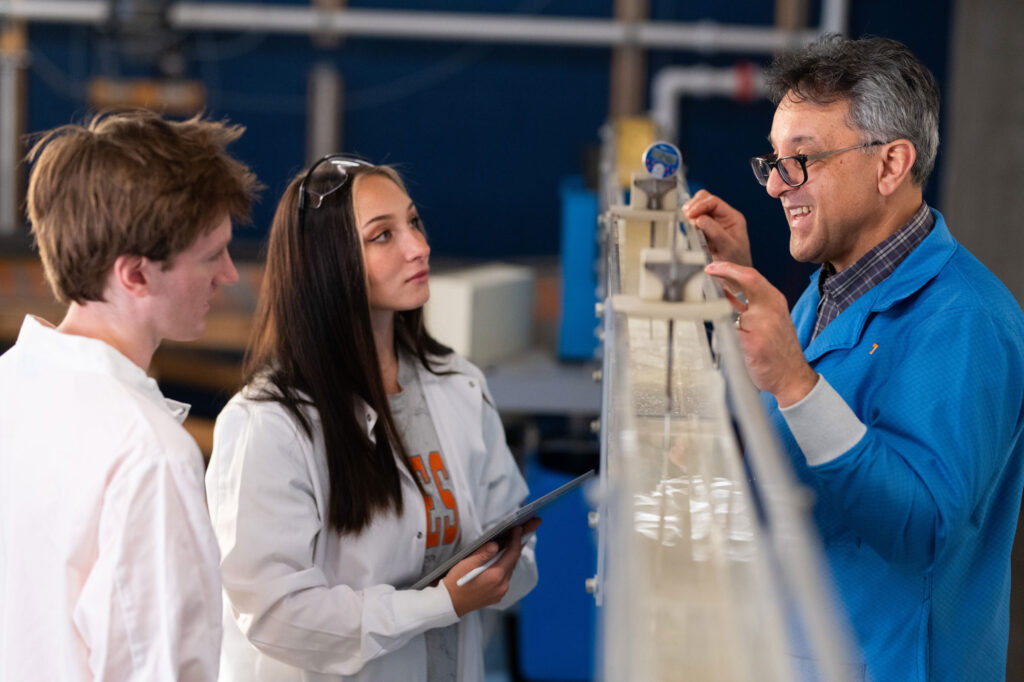 Students work in the lab receiving support from their professor