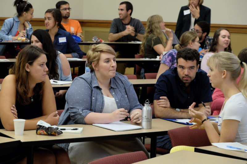 4 grad students discussing teaching at a table