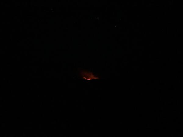 Color photograph of eruption plume and stars