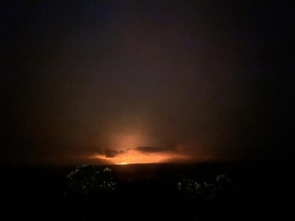 orange glow of lava in the distance at night