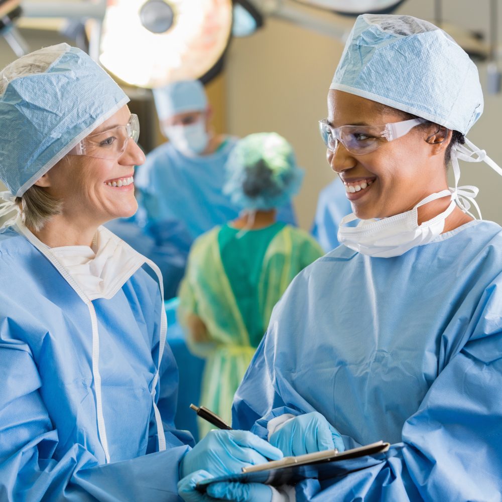 Female surgeons consulting about patient in operating room