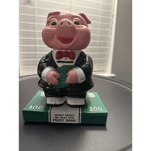 1991 Vintage “Money Makes My Head Spin" talking, head-spin Piggy Bank. Coin