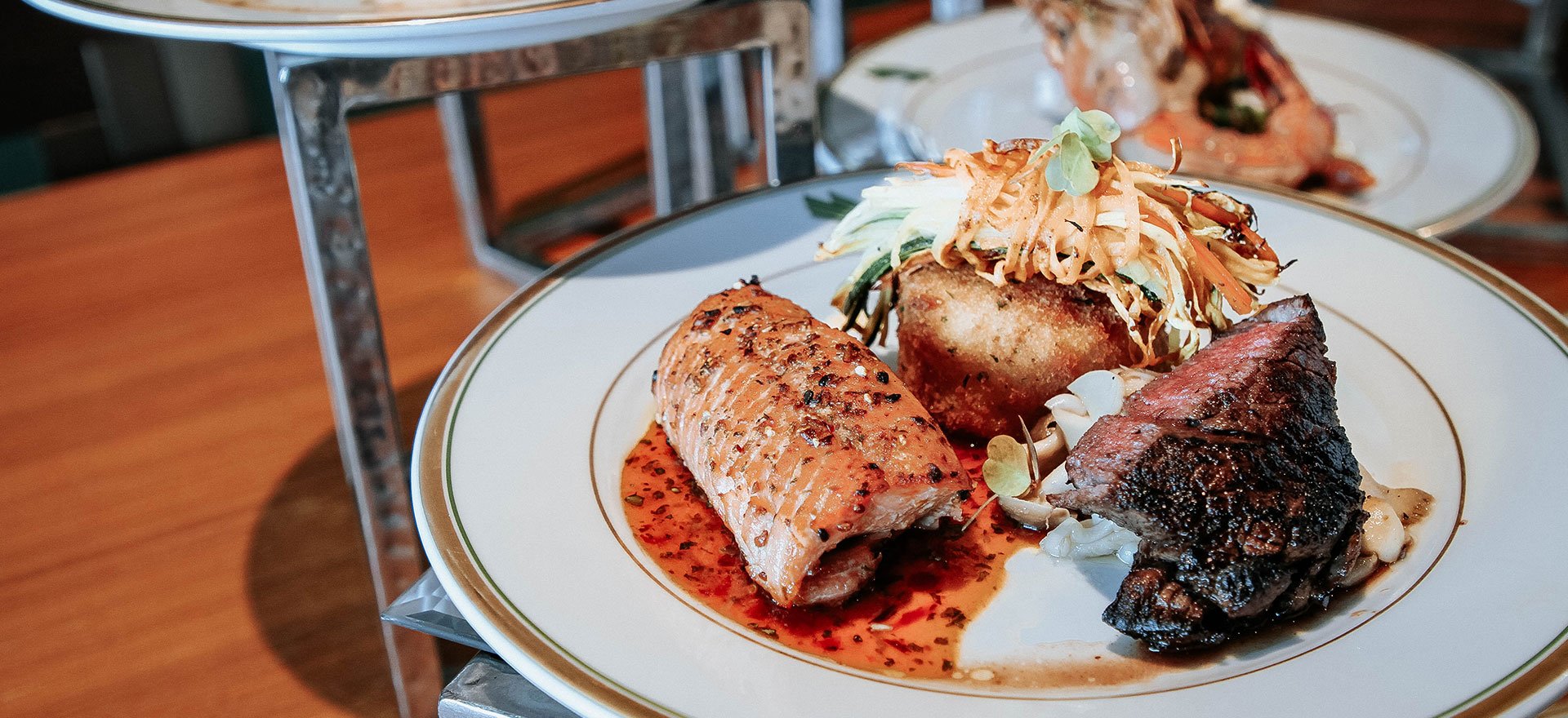 Artisan-styled catering plate with salmon, steak and vegetables