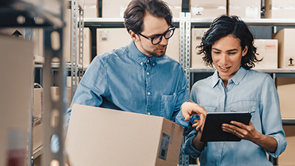 Two people looking at table in storage warehouse