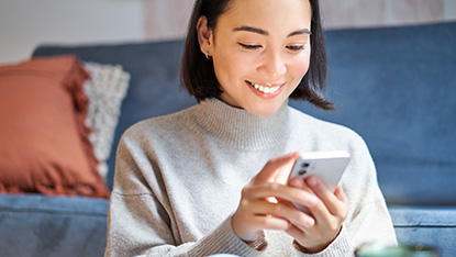 Woman smiling at phone