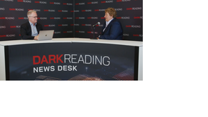 Two people talking at a news desk against a dark backdrop with "Dark Reading" written on it.