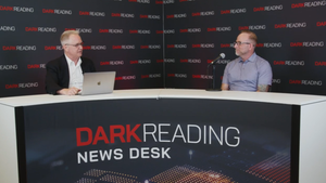 Two people talking at a news desk against a dark backdrop with "Dark Reading" written on it.