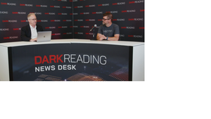 Two people talking at a news desk against a dark backdrop with "Dark Reading" written on it.