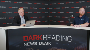 Two people talking at a news desk against a dark backdrop with "Dark Reading" written on it.