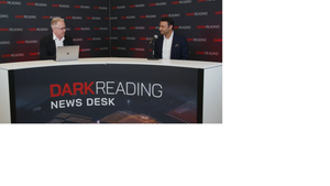 Two people talking at a news desk against a dark backdrop with "Dark Reading" written on it.