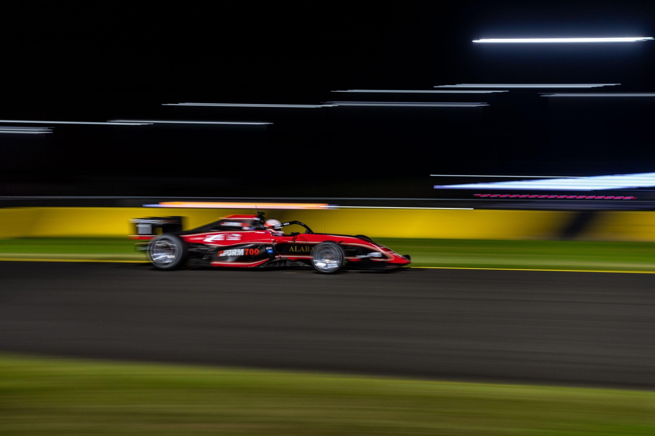 a race car on a track against a blurred background 