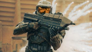 Master Chief from Halo: The Series wields his gun in front of an explosion.