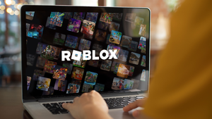 The Roblox logo and artwork on a laptop