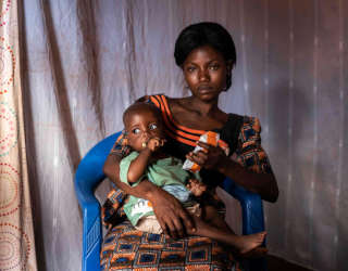 Furaha gives her youngest son Kyungu Evariste a nutritional peanut paste in Kalemie, Democratic Republic of Congo. Photo: WFP/Arete/Fredrik Lerneryd