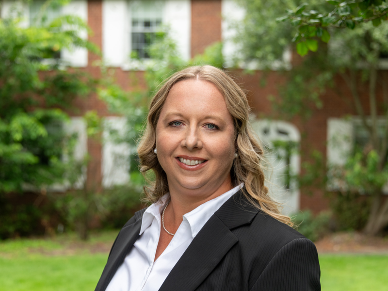 Lindsey-Simon Jones stands in front of the University House at Penn State Fayette, The Eberly Campus.