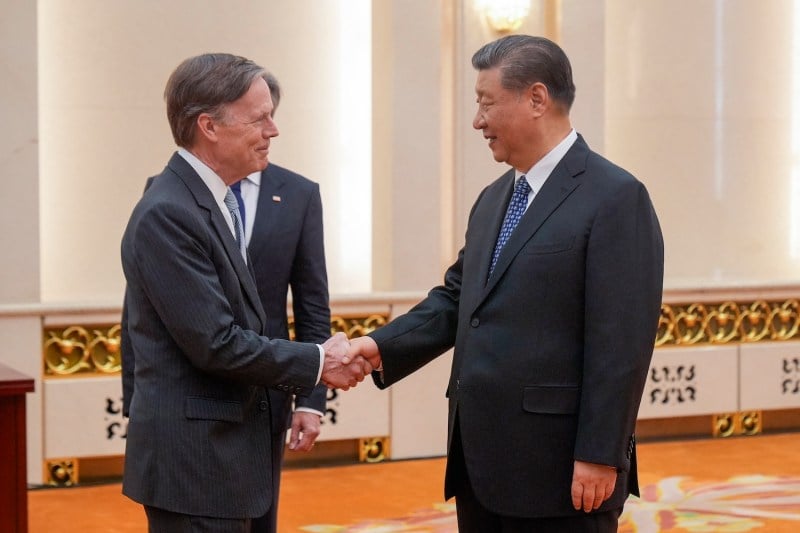 U.S. Ambassador to China Nicholas Burns, left, shakes hands with Chinese President Xi Jinping in Beijing on April 26.