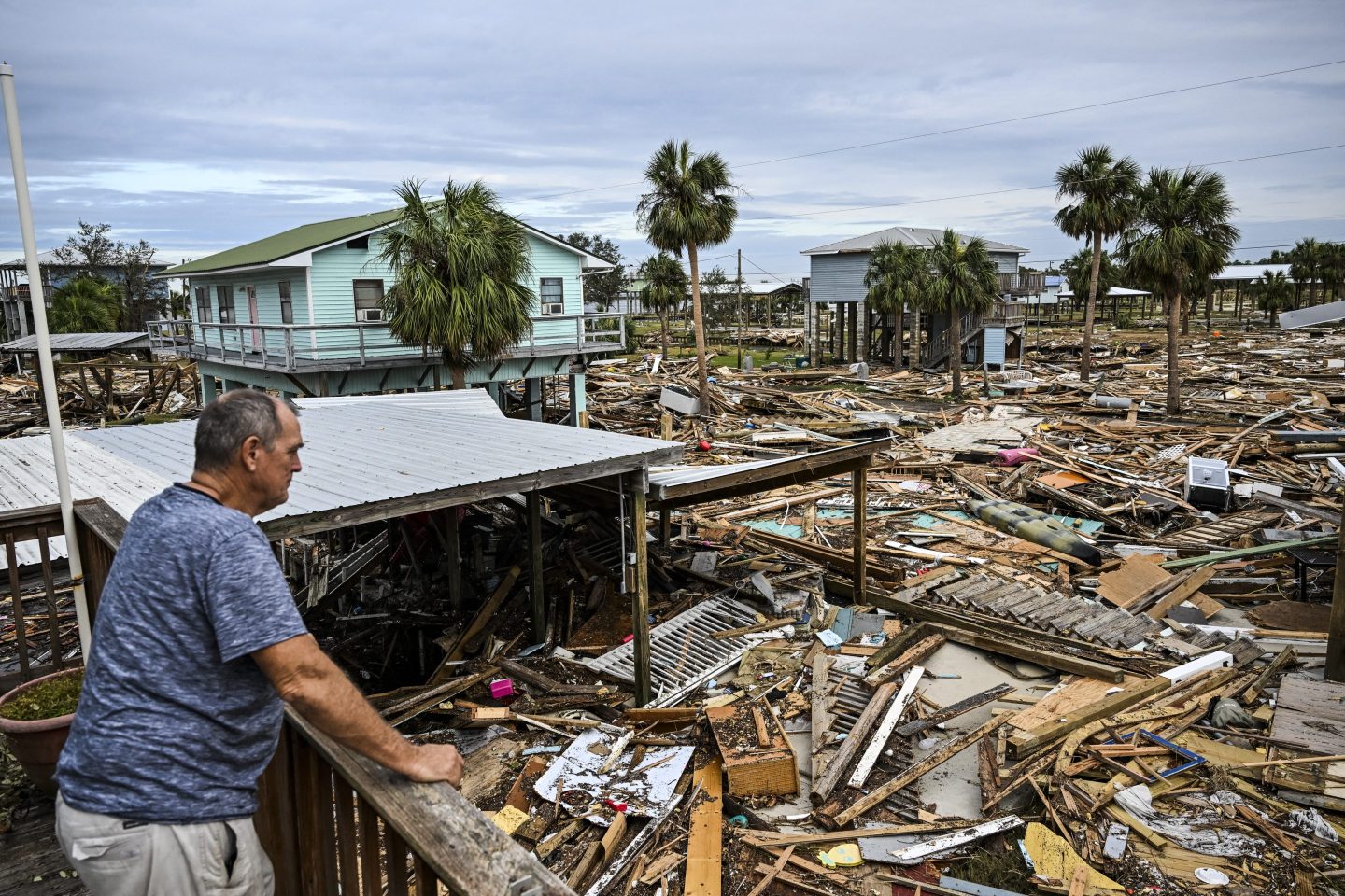 man looks at hurricane damage