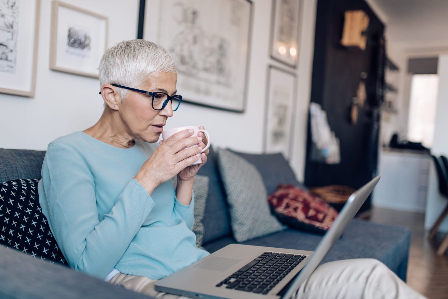 Senior woman working from  her living room.