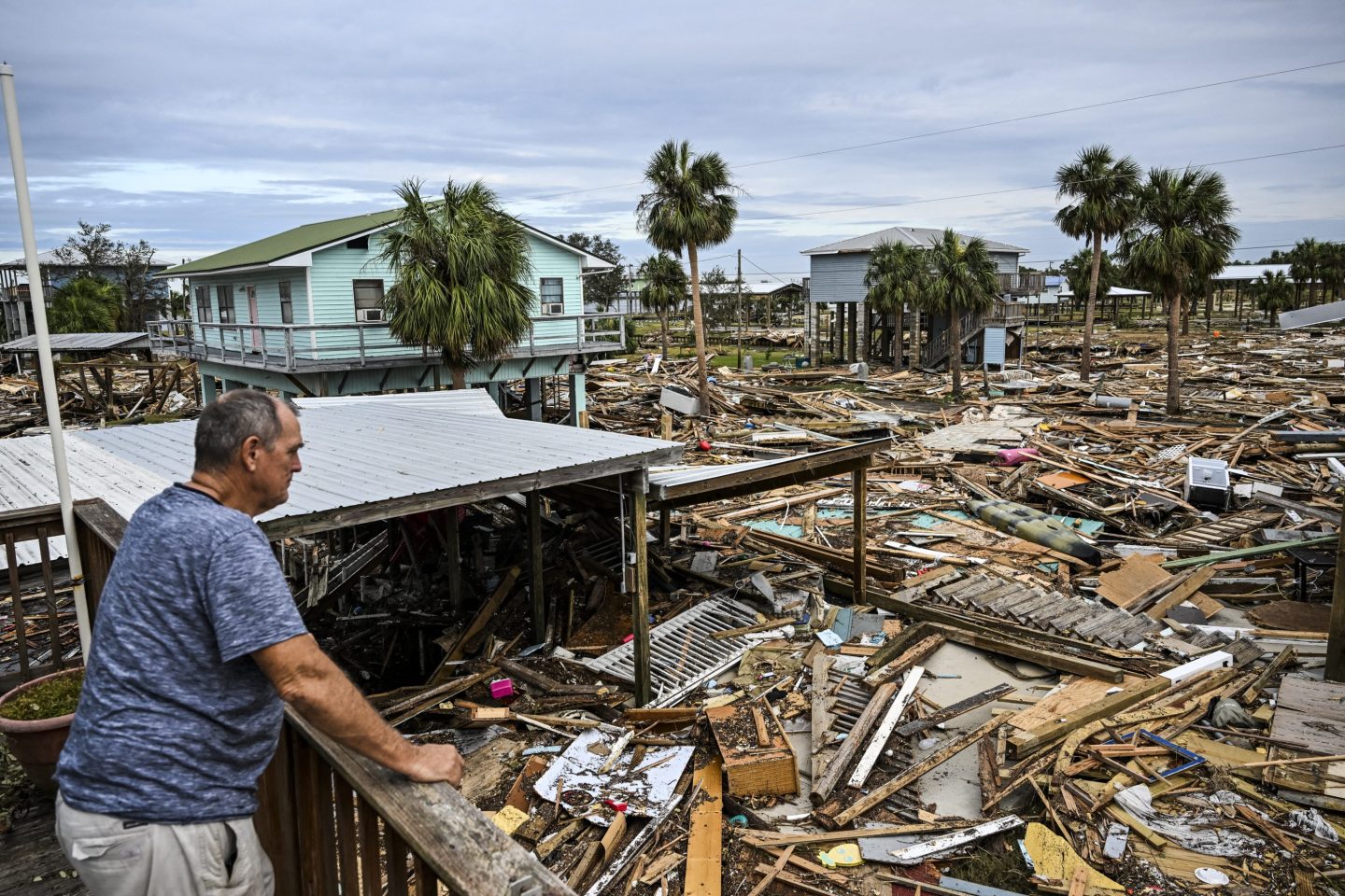 A man inspects the damage done to his home by Hurricane Helene in Florida.