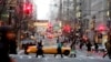 FILE - Vehicles and pedestrians make their way down Fifth Avenue in New York, Dec. 22, 2005. 