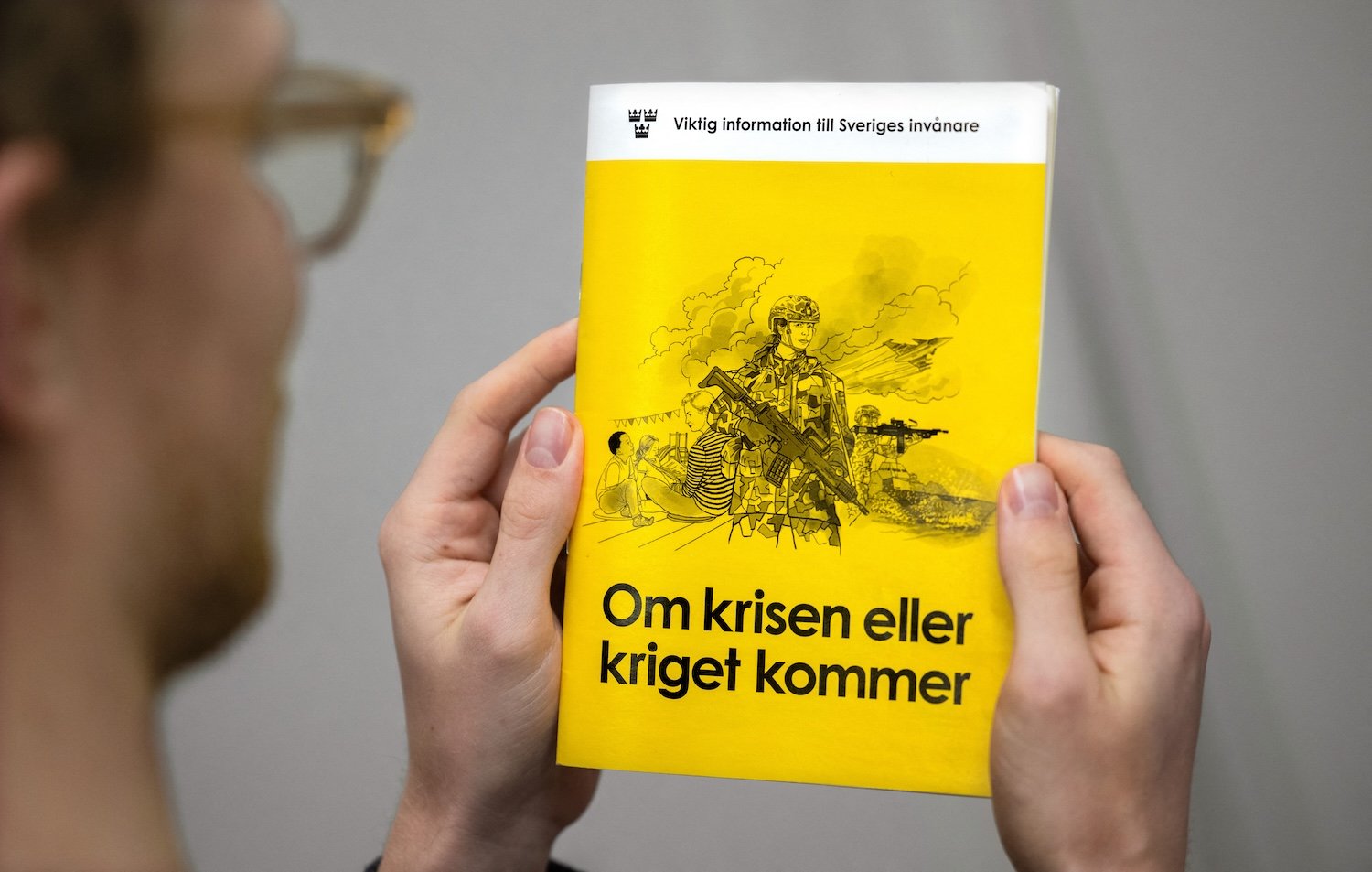 A man holds the new version of the preparedness booklet "If the crisis or war comes", that will be distributed to all households, on November 18, 2024 in Stockholm, Sweden.