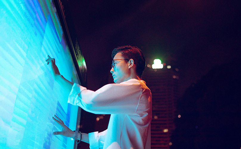 businessman touching screen at night