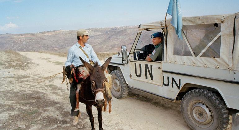 A UNIFIL peacekeeper talk to a local man in the hills of southern Lebanon.