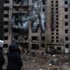 People walk passed a recently bombed building in Kyiv, Ukraine, in January 2024.