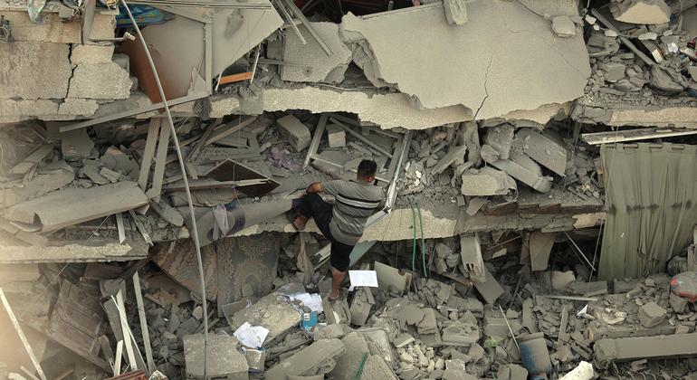 A man climbs up a destroyed building in Gaza.
