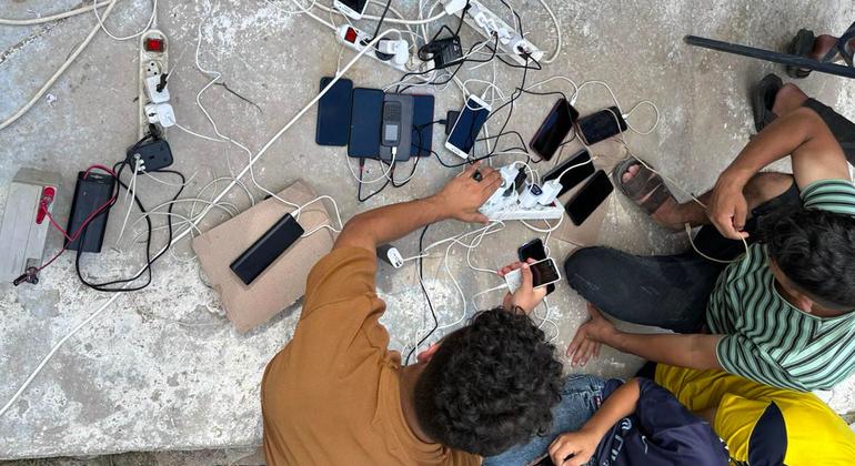 People caught up in the conflict in Gaza recharge their mobile phones.