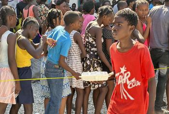 Children in Haiti line up for a hot meal and water distributed by the World Food Programme (WFP) in Port-au-Prince.