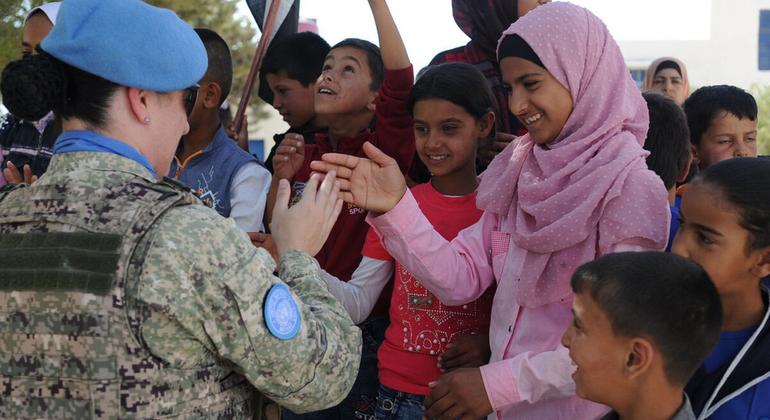 A peacekeeper greets the students of the Faouar School in Syria which was one of the four schools that was refurbished by the UN Disengagement Force.