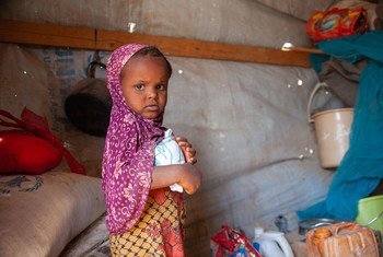 A three-year-old girl receives WFP food assistance at an IDP shelter in Taiz, Yemen.