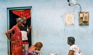 Elodie's family at the doorstep of their home in Abidjan, Côte d'Ivoire.