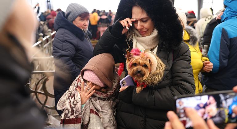 On 27 February 2022, with temperatures close to zero degrees Celcius, a child wrapped in a blanket keeps herself warm as she and her family wait to board an evacuation train in Lviv, in Ukraine's westernmost corner, near the Polish border.