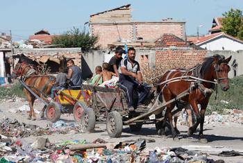 Members of the Roma community in Europe continue to face hardships and discrimination, with many living in poverty. In this file photo, a Roma men and children work at a junkyard in Bulgaria.