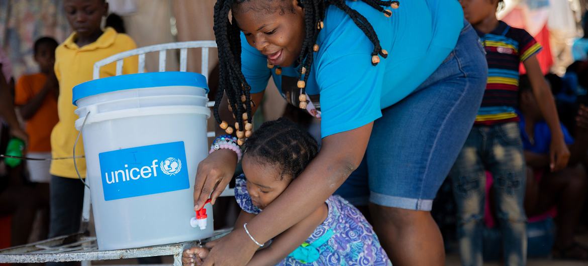 A mother and daughter attend a handwashing training session in Port-au-Prince, Haiti.