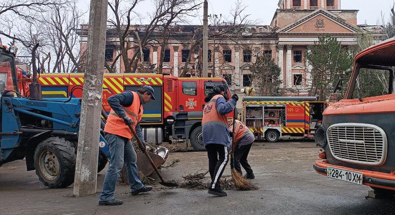 Municipal workers clear up the remnants of shelling in Mykolaiv.  