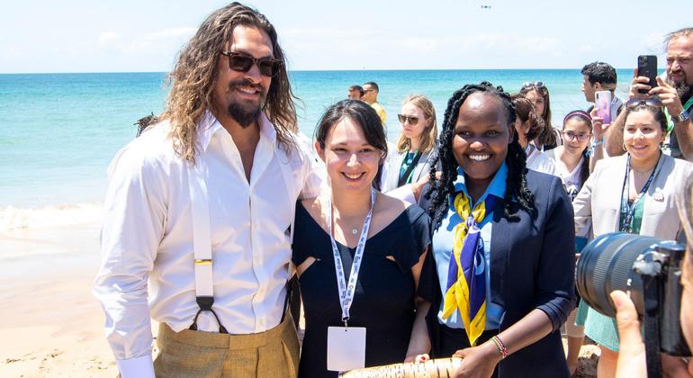 Actor and ocean advocate Jason Momoa (left) meets youth advocates on Carcavelos Beach in Lisbon, Portugal at the UN Ocean Summit.