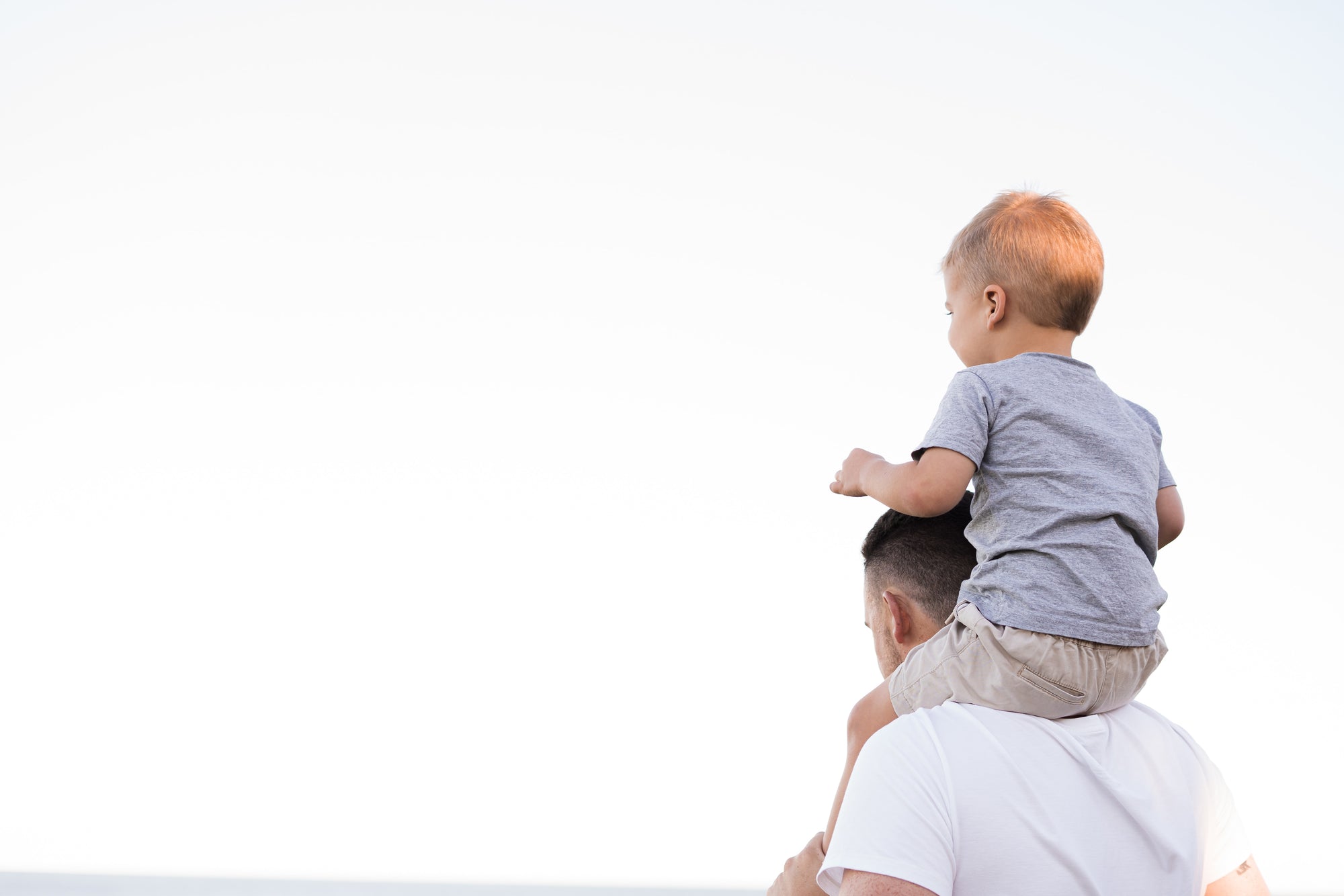 Father carrying son on his shoulder